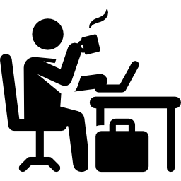 Person at desk drinking coffee